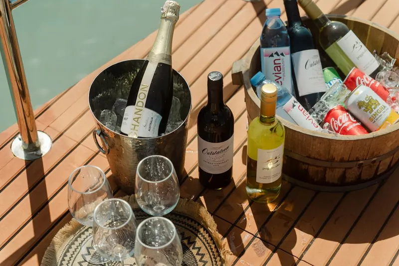 Sparkling wine, wine and soft drinks on ice on the catamaran deck
