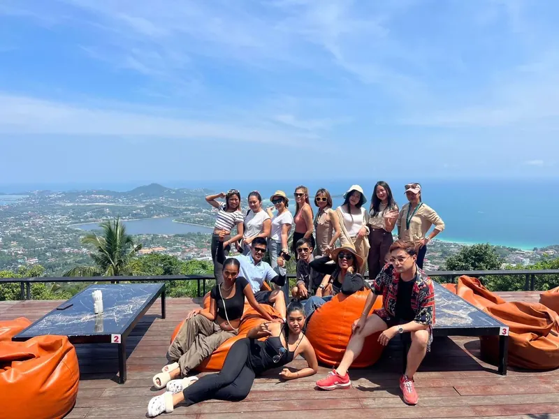 A group of guests at a hilltop viewpoint overlooking the Koh Samui coast